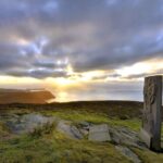 Ancient monument on clifftop at sunset