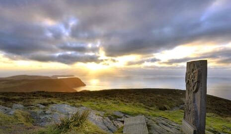 Ancient monument on clifftop at sunset