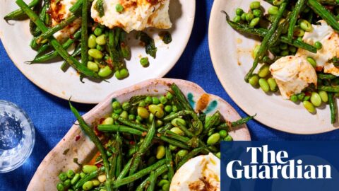 Plates laid out on a table with a blue tablecloth, with the mozzarella and green bean salad on top