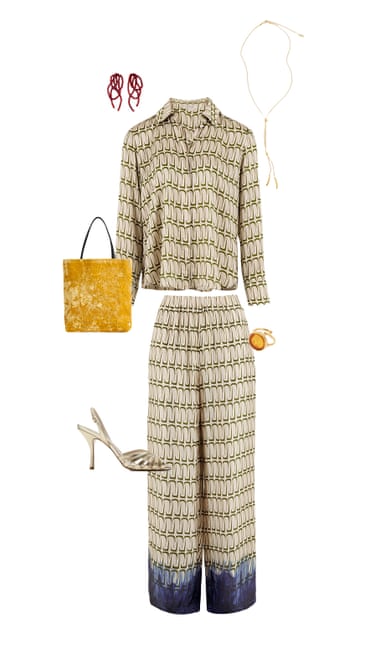 A composite image of a beige chain print silk shirt and matching silk trousers, gold beaded earrings, long gold "Y" chain, gold ring with an orange stone, gold high heel cage sandals and a yellow velvet evening bag on a white background
