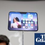 People taking pictures of the new iPhone Duo at its launch in California.