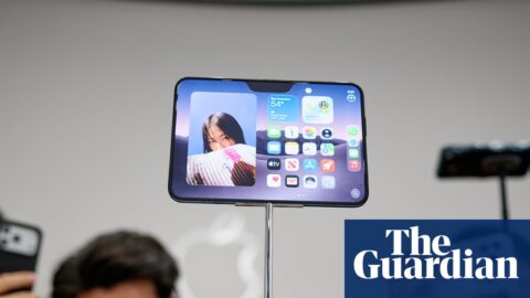 People taking pictures of the new iPhone Duo at its launch in California.