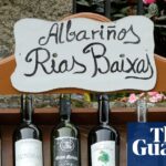 A wooden shelf displays Albariño wine bottles under a hand-painted "Rias Baixas" sign