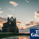 Whitby Abbey ruins with sunset and reflections.