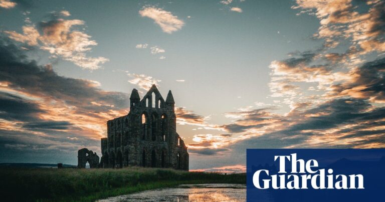 Whitby Abbey ruins with sunset and reflections.