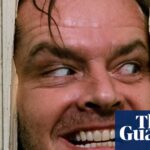 Jack Nicholson grins manically through a hole he hacked in a wooden door